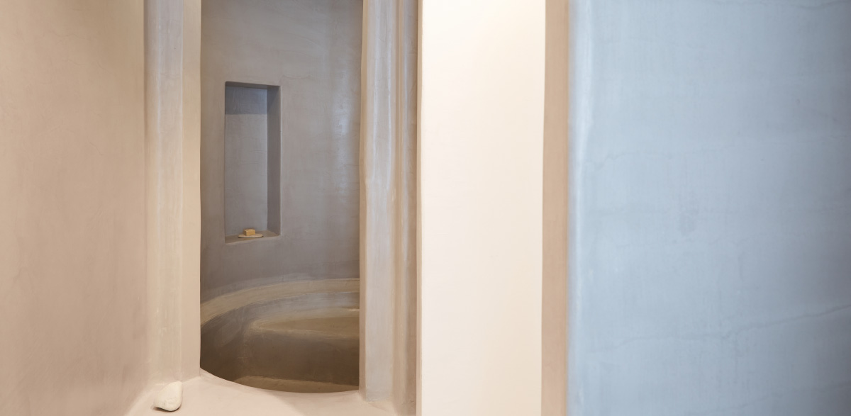 03-polished-stone-shower-mykonos-blu-apartment-sharing-pool
